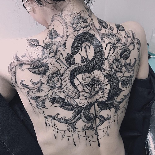 Hình xăm con cái rắn và hoa kiểu mẫu đơn bên trên sống lưng cô gái
