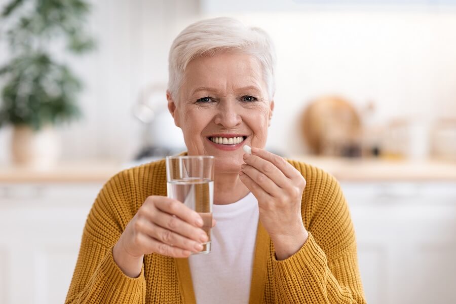 A senior woman taking multivitamins