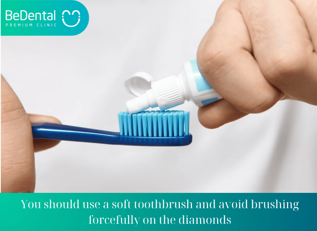 You should use a soft toothbrush and avoid brushing forcefully on the diamonds